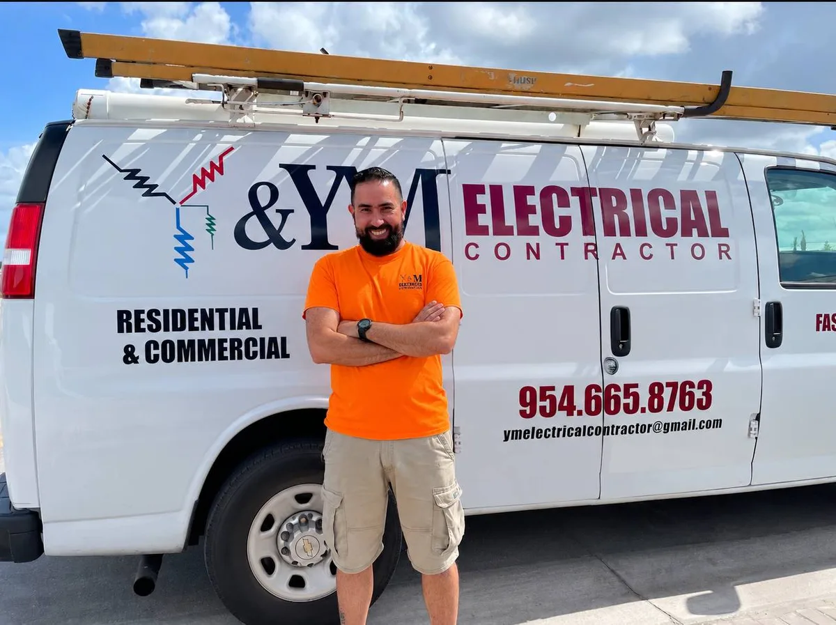 Yosdany Lorenzo, founder of Y&M Electrical Contractor, in front of the company van