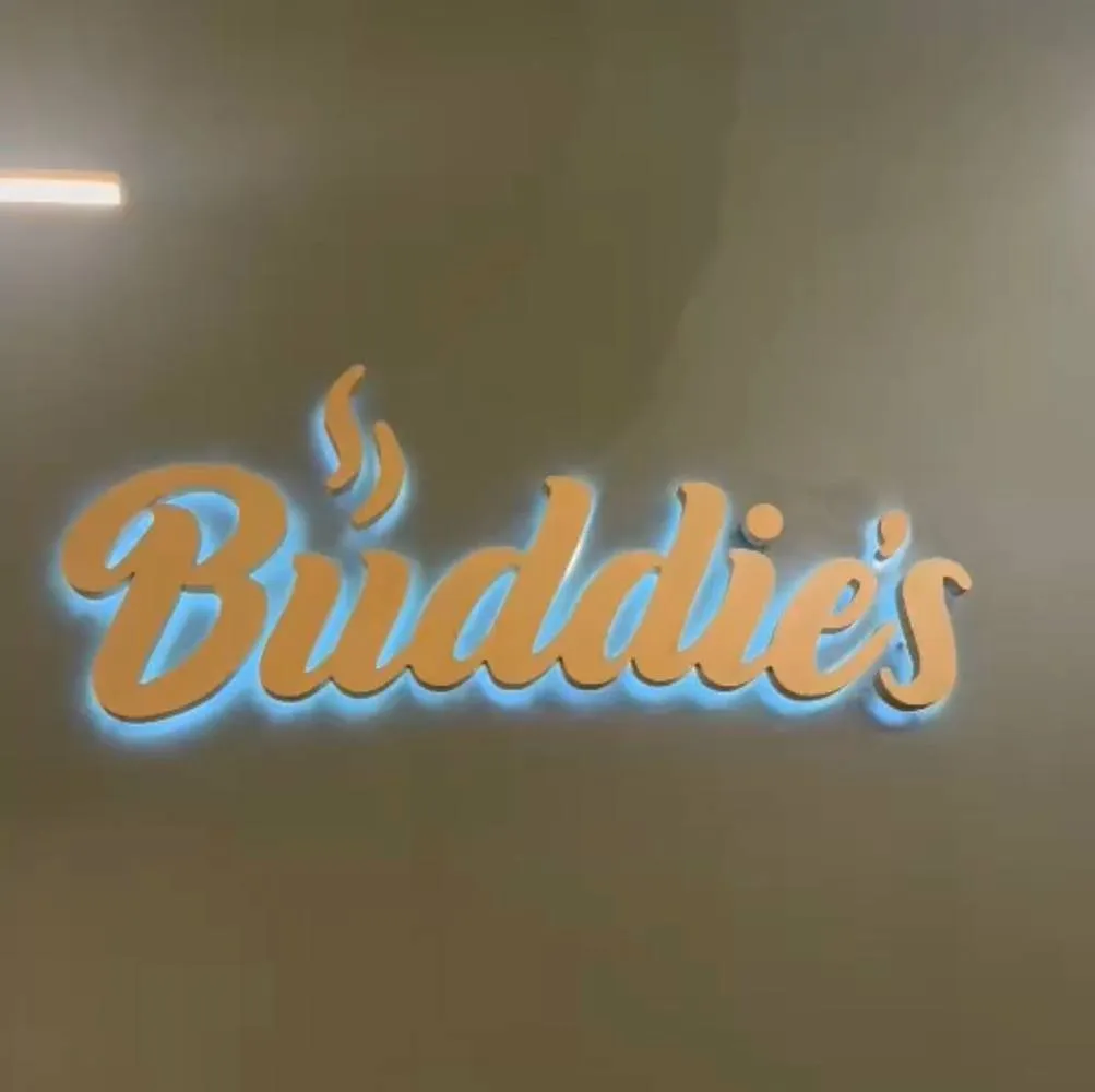 Backlit gold channel letter sign with blue LED halo glow in a coffee shop