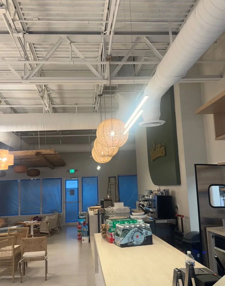 Cafe dining room with rattan pendants and high-bay lighting