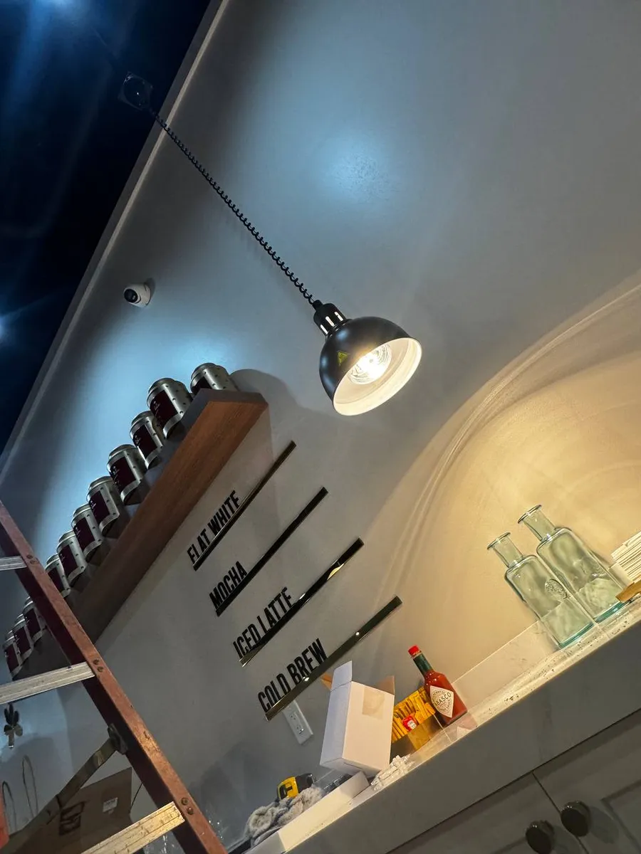 Cafe interior with pendant lighting and menu wall