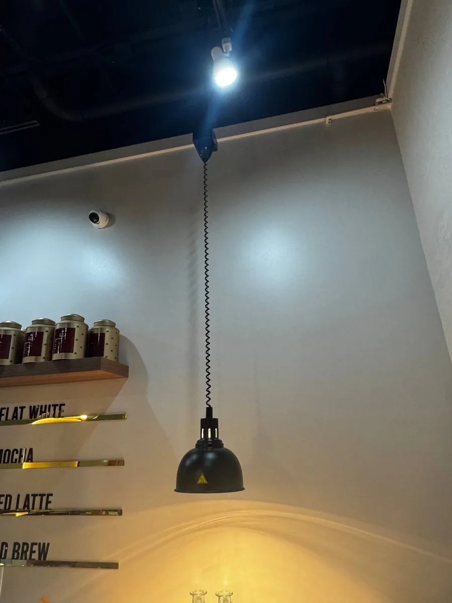 Pendant lamp installed over a coffee shop counter