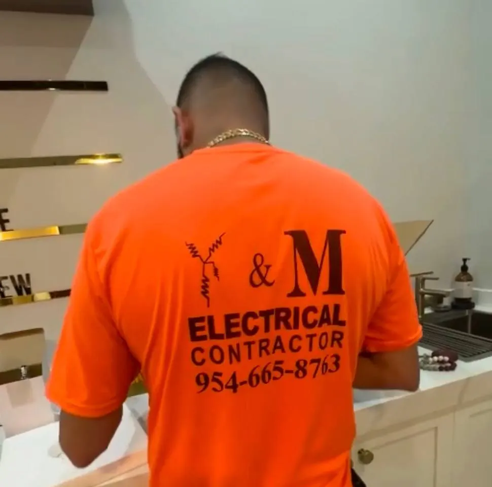 Y&M electrician working at a commercial kitchen counter