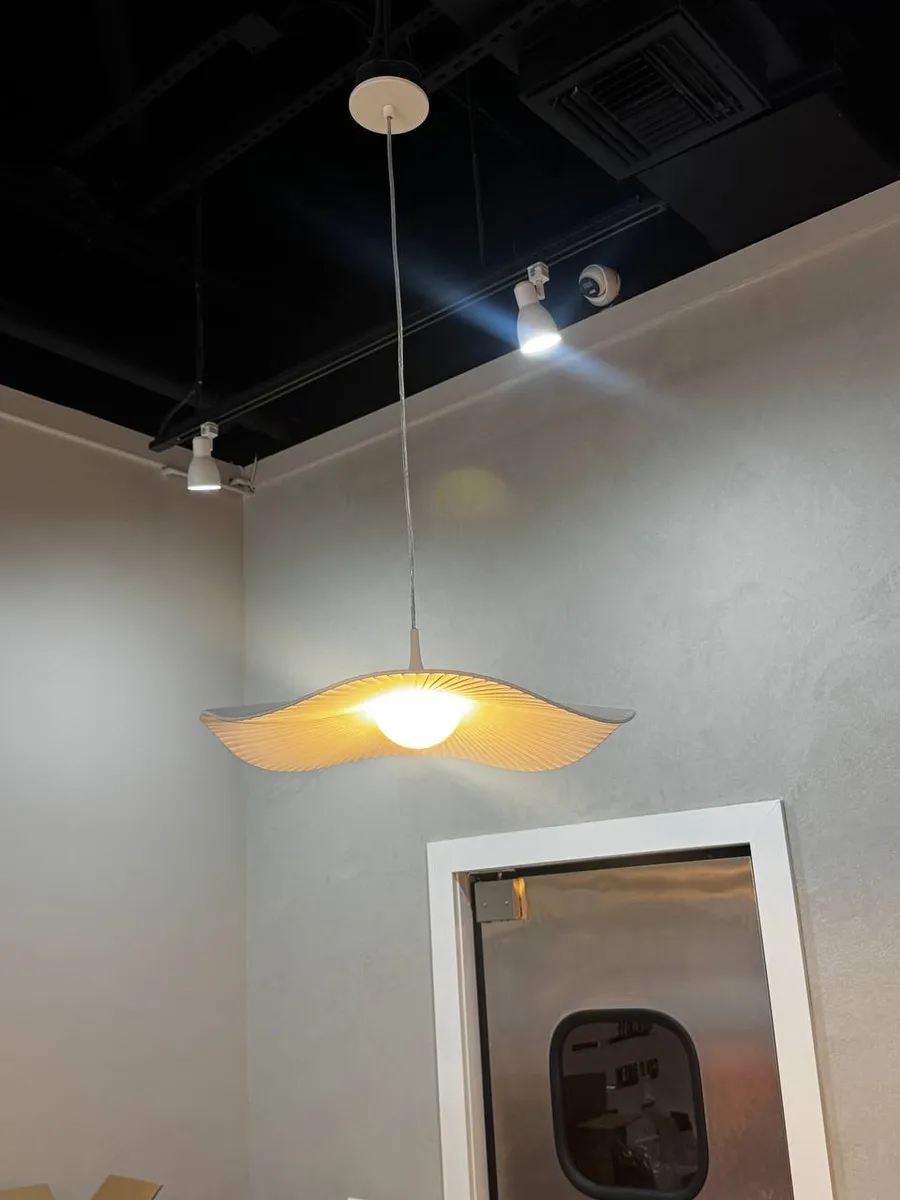 Designer wave pendant light with track spotlights