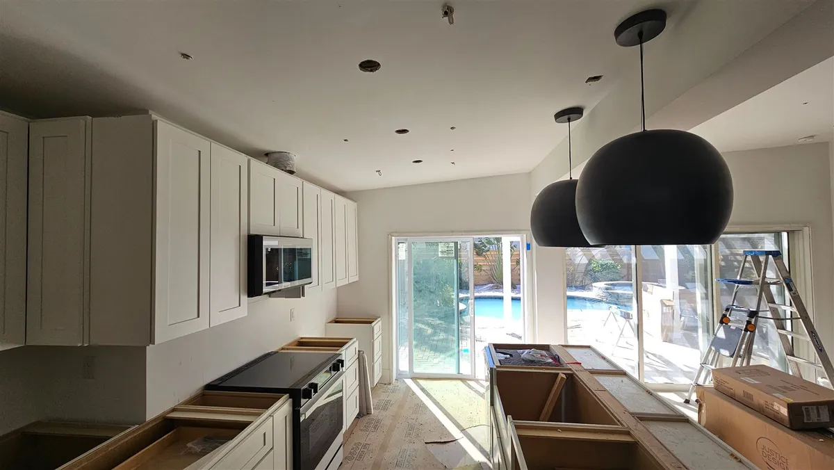 Kitchen with new recessed and pendant lighting