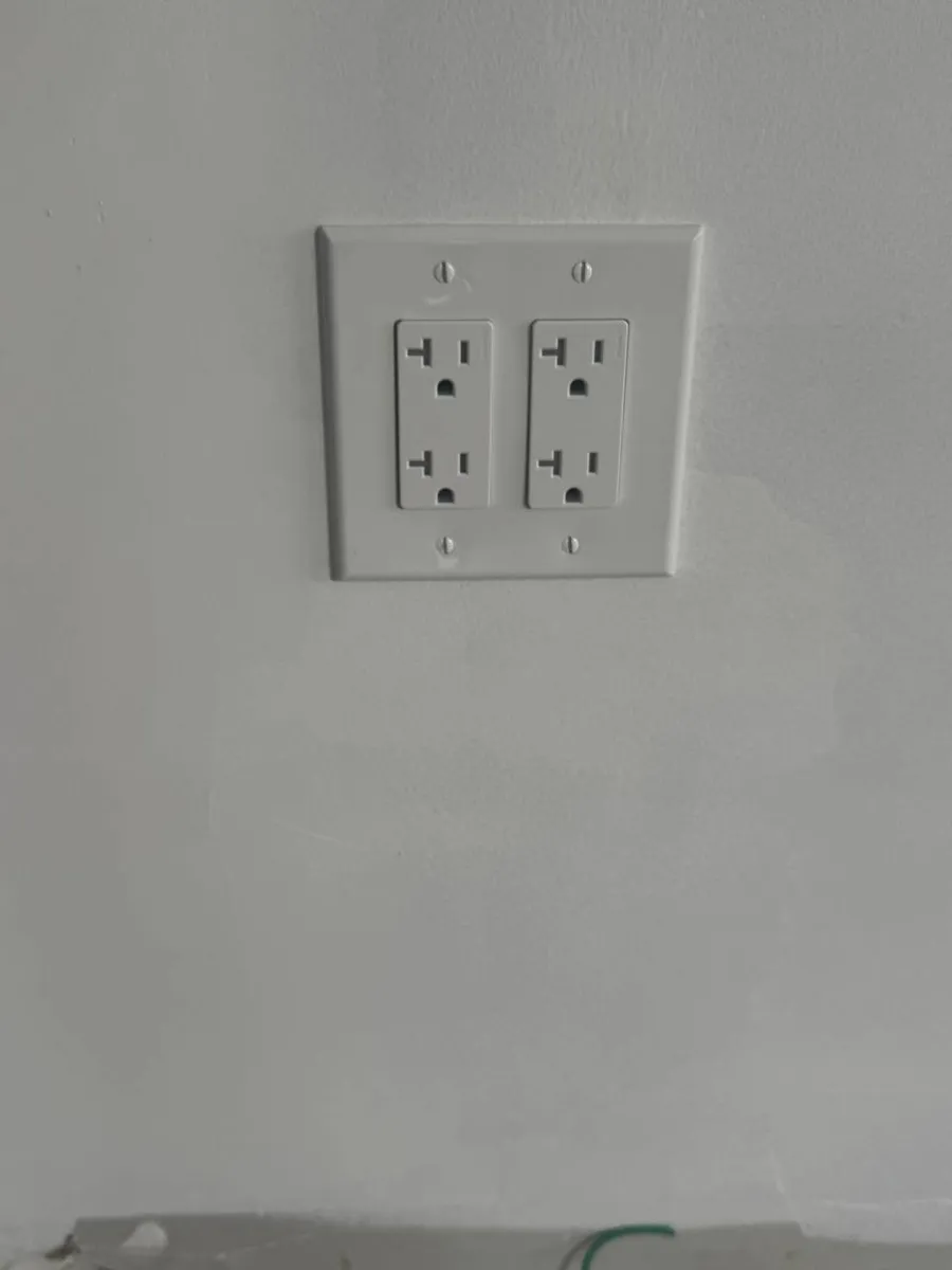 New double duplex outlet installed on a white wall