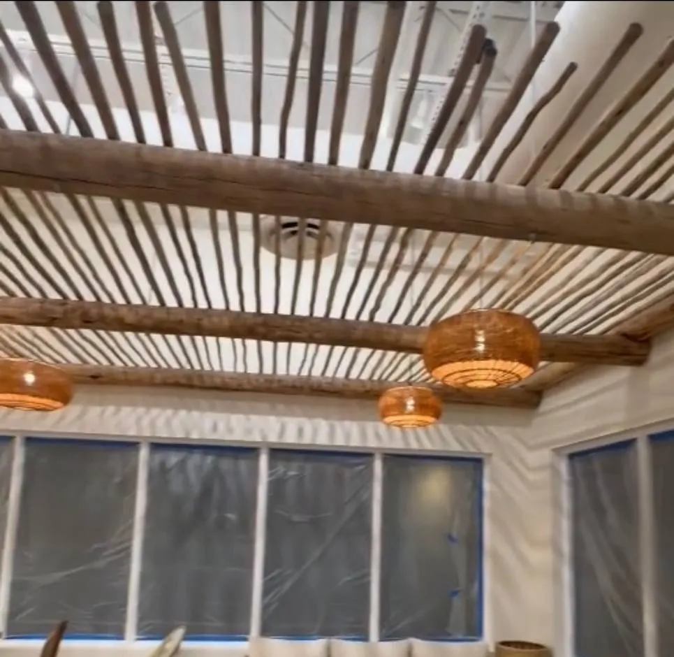 Pendant lighting under a wood slat ceiling feature