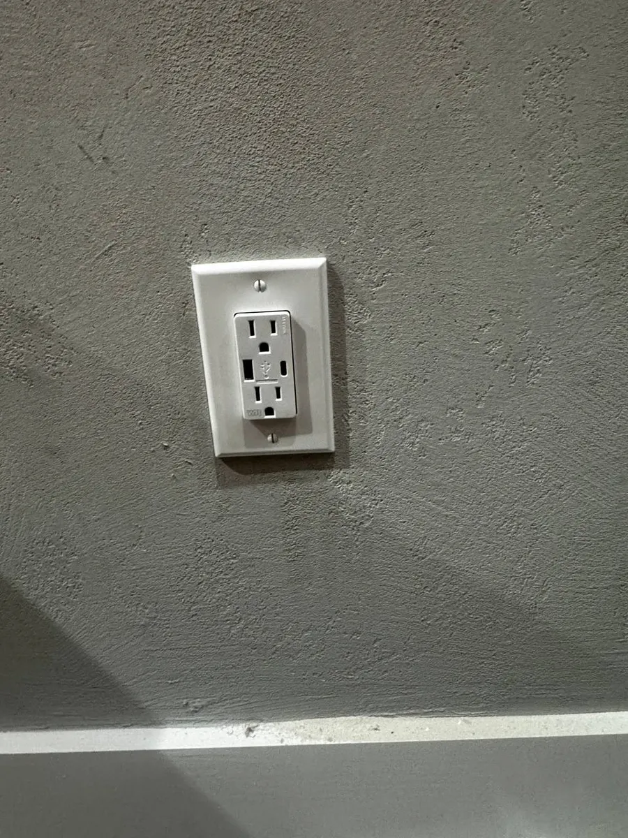 New outlet with USB charging ports on a textured wall